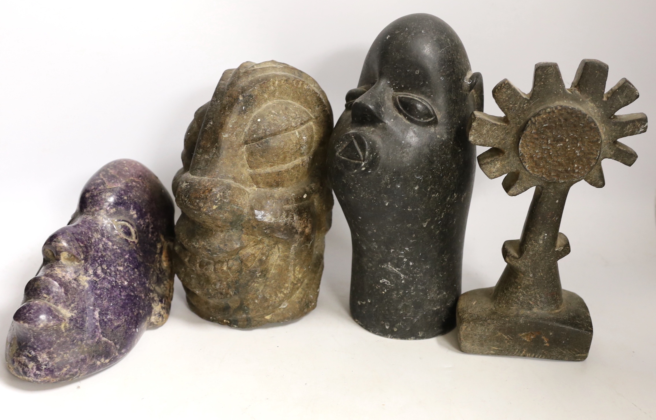 Ten Shona stone carvings, 1960s-70s, including three heads, the first in purple Lepodolite signed Conrad Nyagwande, one signed Amani the other initialled NM, a tortoise, a monkey, a gecko box and abstract sculpture forms
